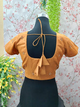 Light orange blouse with small golden as bhutas